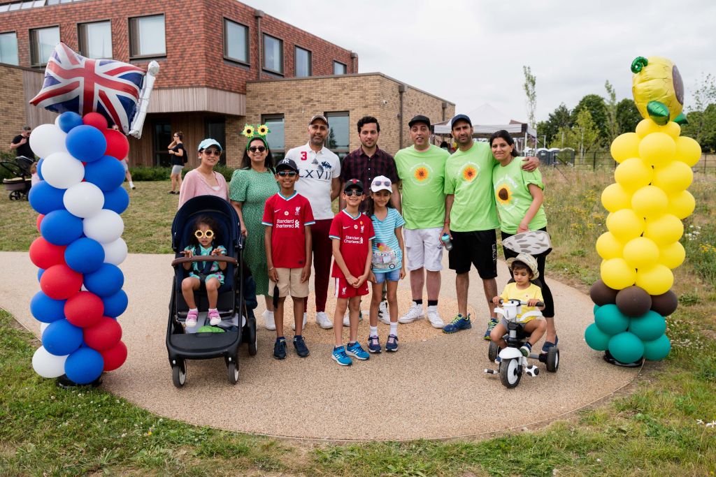 Family enjoying the Sunflower Walk at Thames Hospice